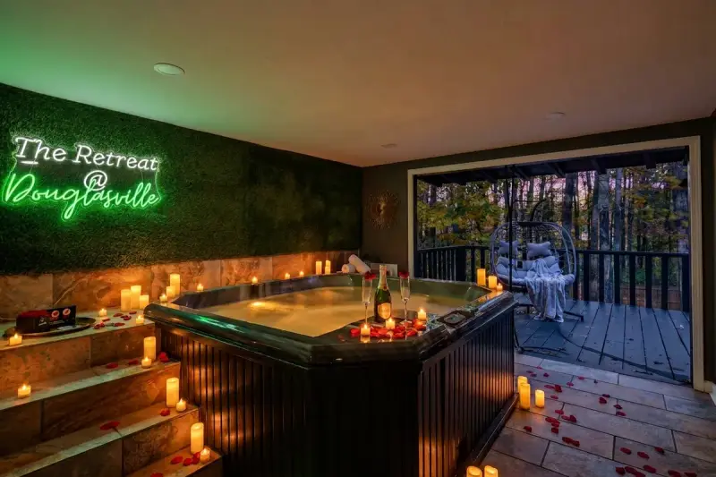 Private hot tub at night with steam and string lights